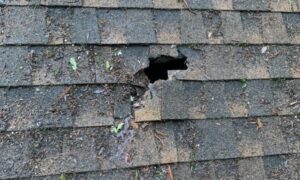 A puncture in composite shingle roof causing a leak that must be repaired by a roofing company in Aptos CA.